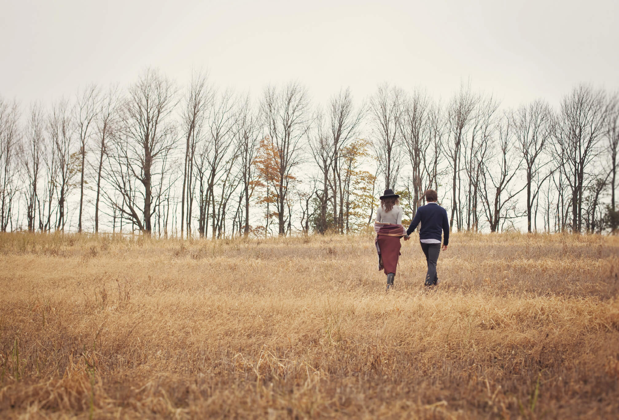 running in a field couple engagement