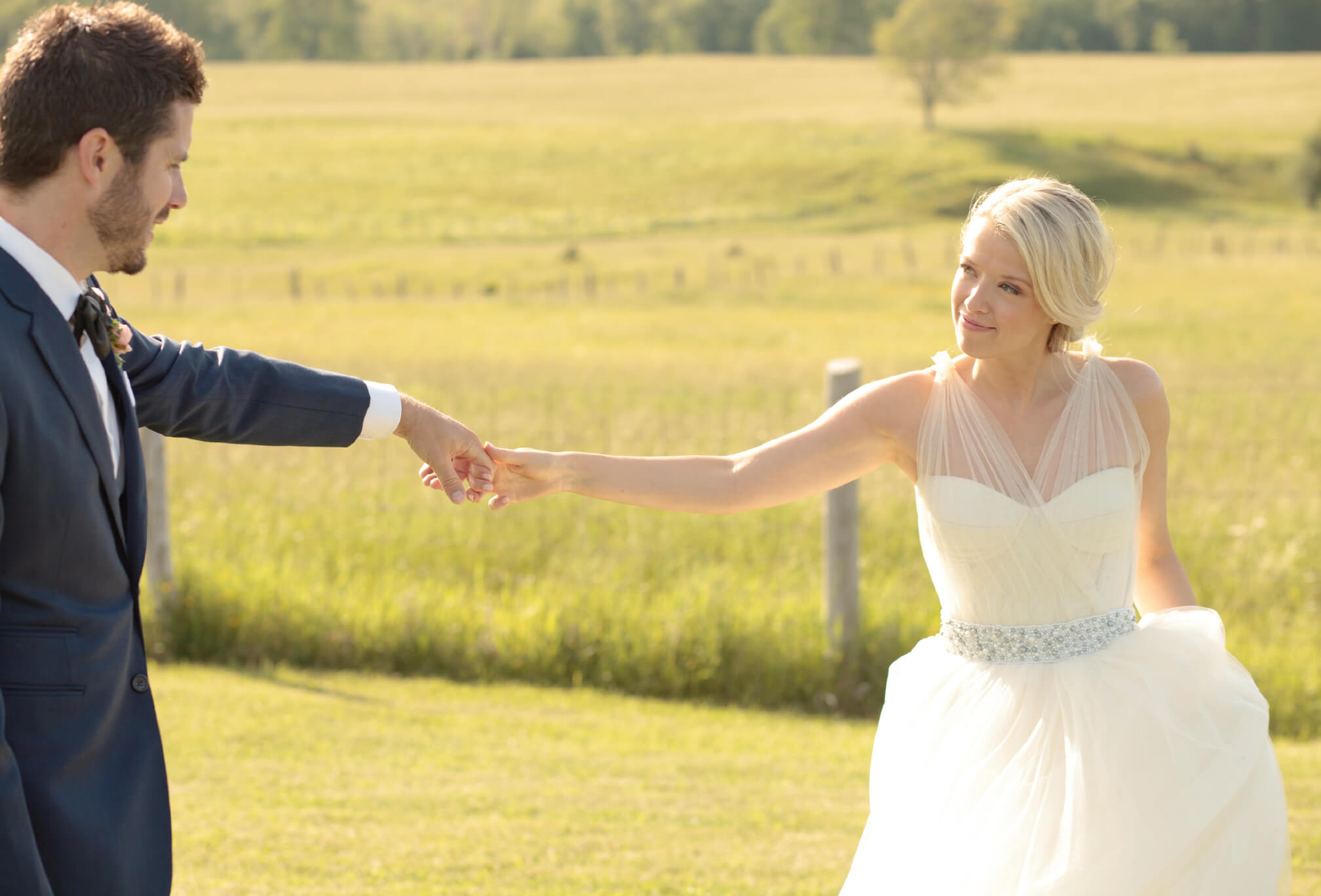 dancing in a field bride and groom