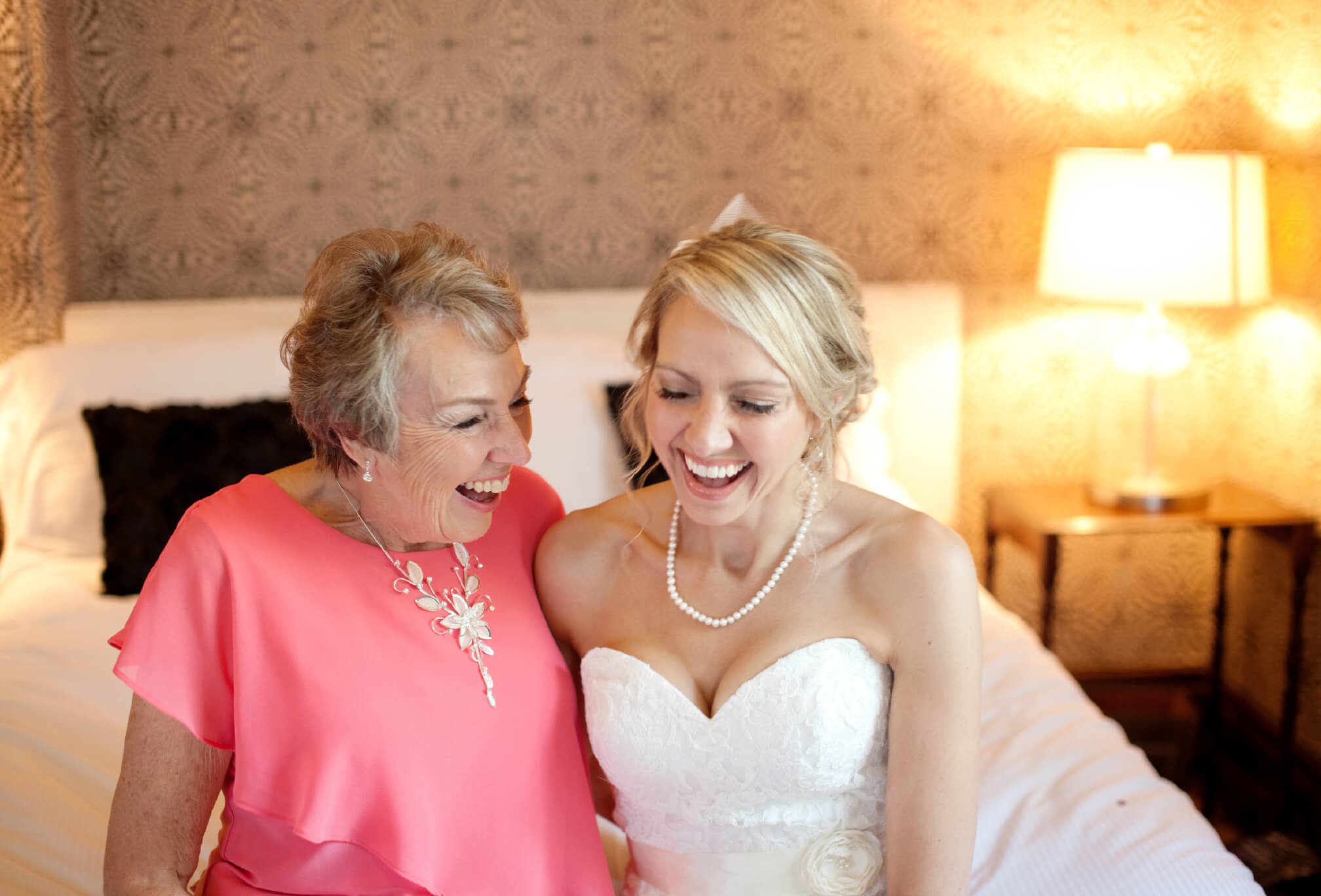 bride and mom laughing