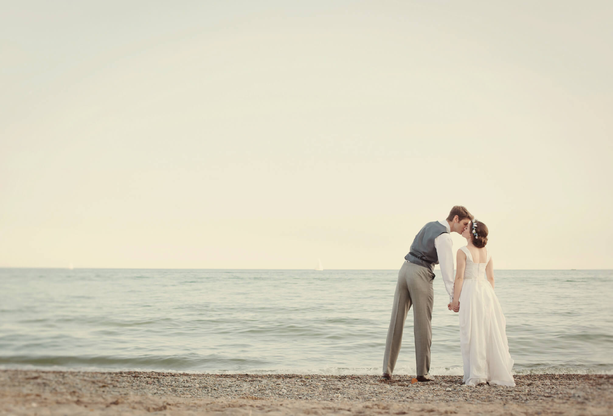 bride and groom on beach toronto sunset