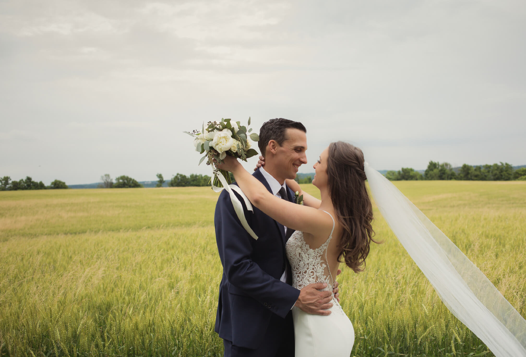 bride and groom in wheat field